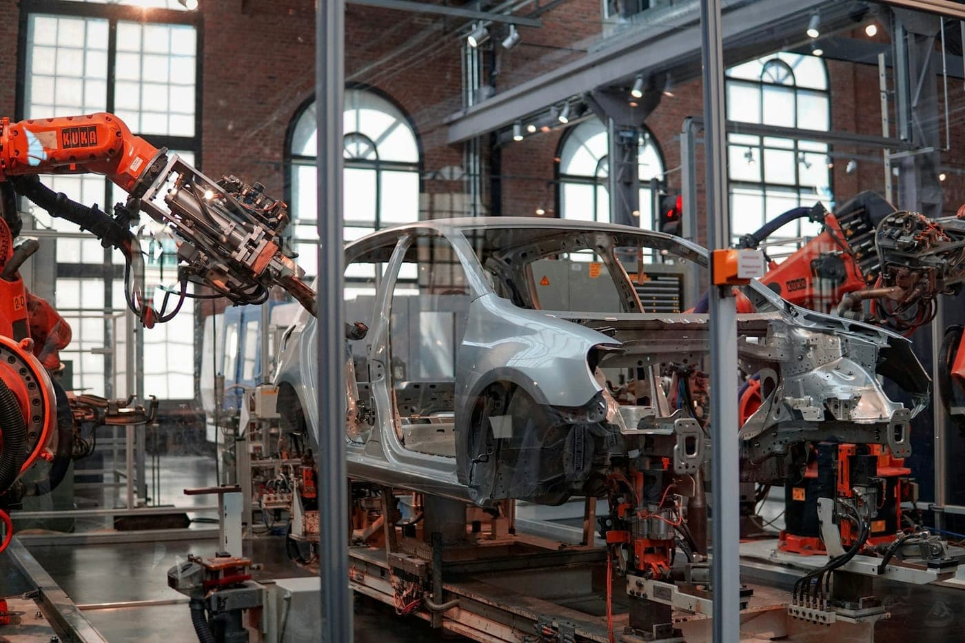 Robot arms around a car body on an assembly line
