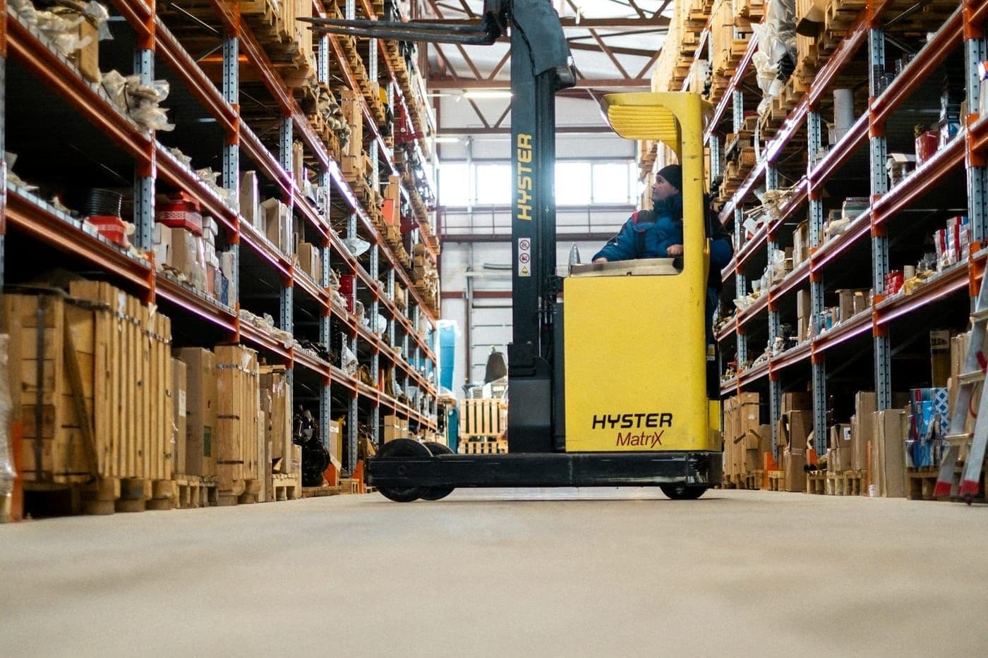 A reach truck in a racked warehouse aisle