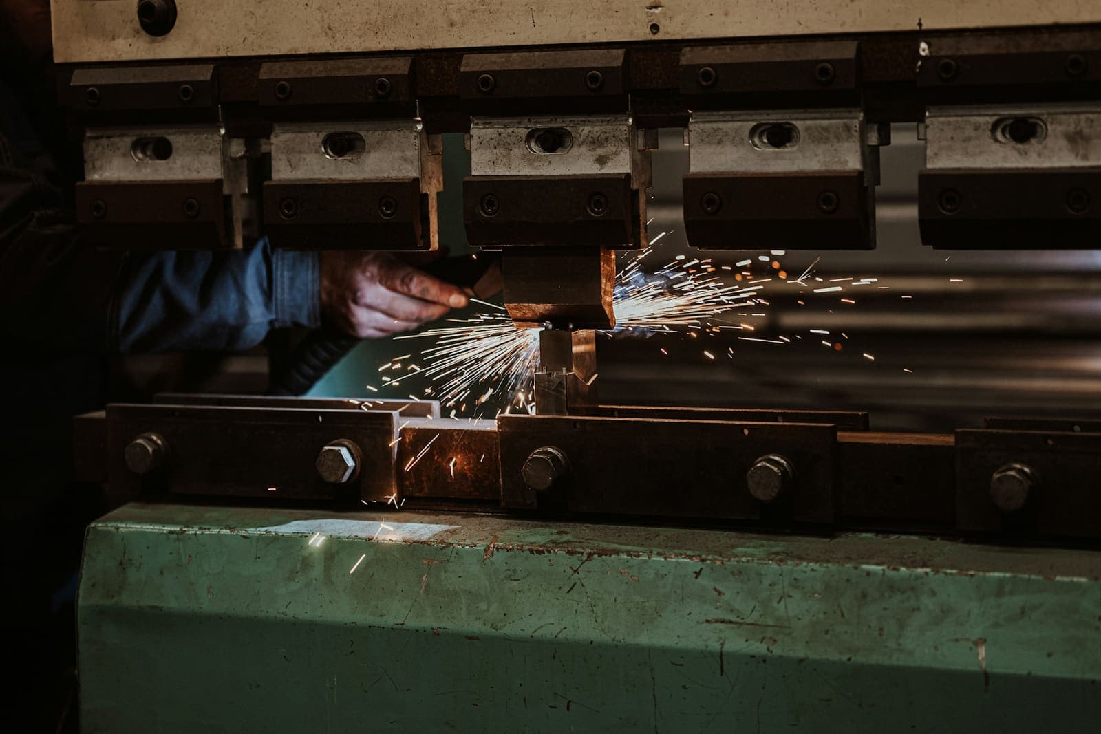 Press brake tooling over a steel sheet in a fabrication shop